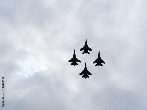 Bild auf Leinwand four military fighter jets silhouettes isolated on sky  with copy space
