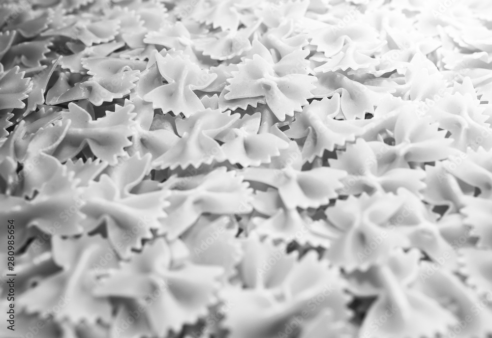 Fototapeta premium Pasta from durum wheat. Raw farfalle. Healthy food. Italian dishes.