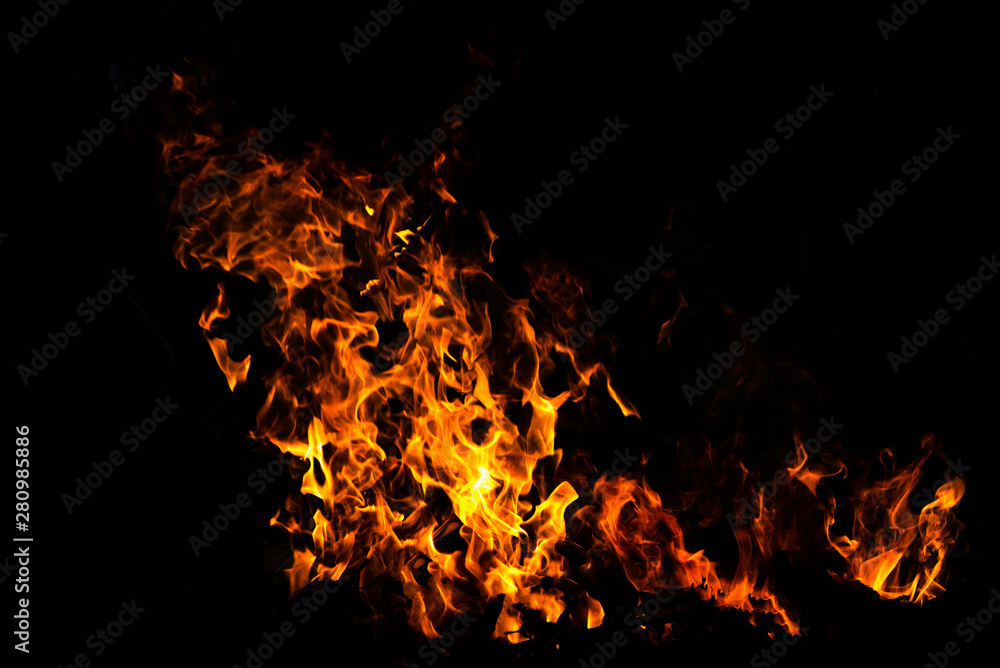 Fire flames on Abstract art black background, Burning red hot sparks rise from large fire in, Fiery orange glowing Fire flames on Abstract art black background, Burning red hot sparks rise from large fire in, Fiery orange glowing