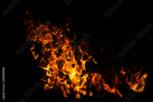 Fire flames on Abstract art black background, Burning red hot sparks rise from large fire in, Fiery orange glowing