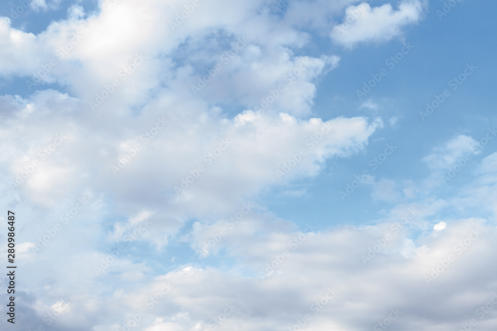 White fluffy clouds in the blue sky in summer