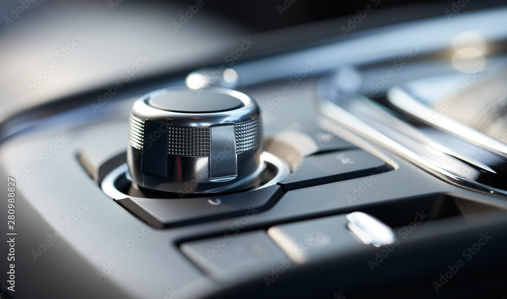 Closeup of a modern car interior with media and navigation control buttons Closeup of a modern car interior with media and navigation control buttons