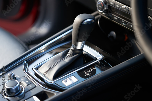 Vehicle interior of a modern car with media and navigation control buttons © jamesteohart
