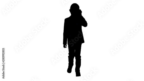Silhouette Little boy in a costume making a phone call while walking. photo