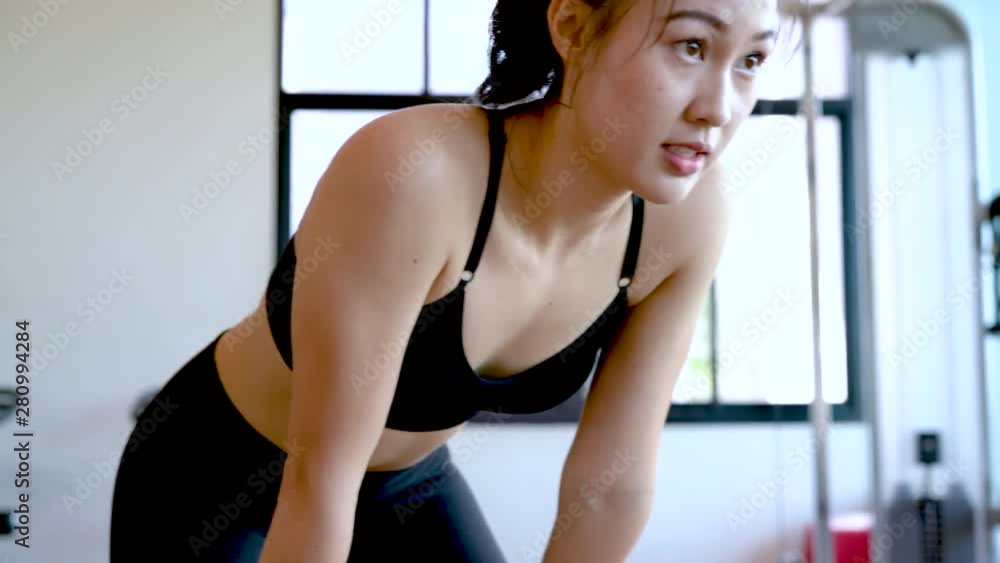 Woman fitness focused in the gym workout exercise building muscle and fit body people healthy lifestyle concept slow motion 4k resolution. Woman fitness focused in the gym workout exercise building muscle and fit body people healthy lifestyle concept slow motion 4k resolution.