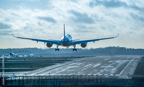Airplane landing to airport runway photo