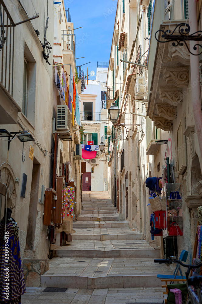 Narrow idyllic streets in ancient Vieste, a small fishing town along the Adriatic Sea in the puglia region of Italy.