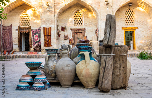 Large earthenware jugs in inner yard of old center of Bukhara, Uzbebkistan photo