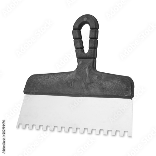 Notched spatula on white background. Handle notched spatula on white background. Stainless steel notched spatula with plastic handle