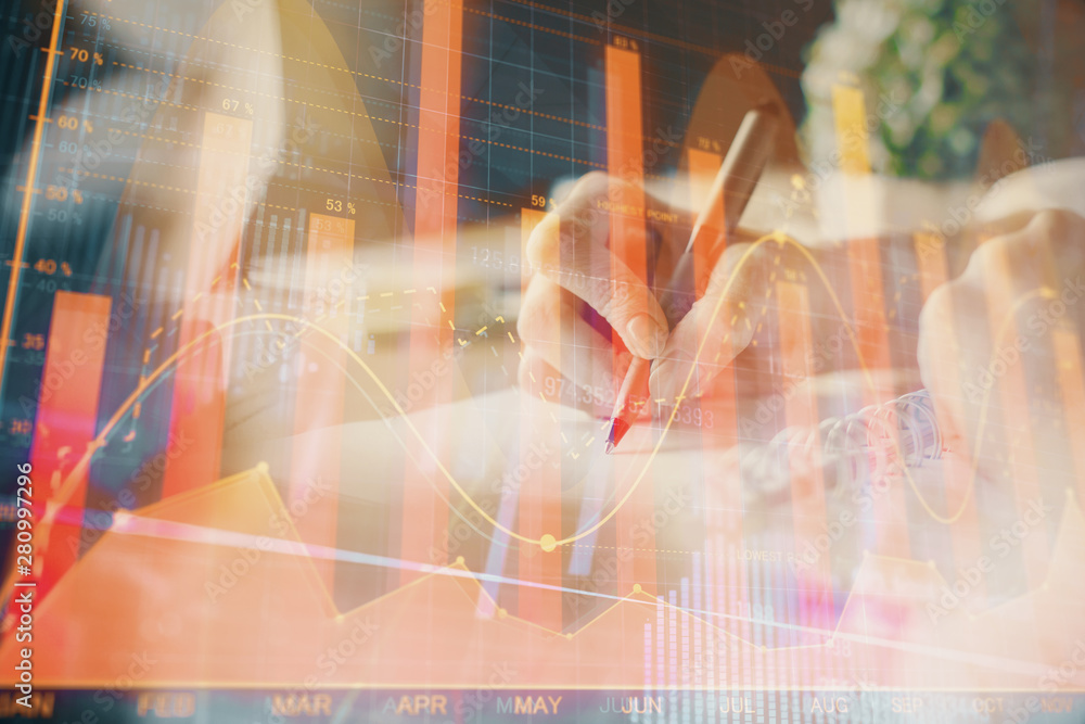Financial forex graph displayed on hands taking notes background. Concept of research. Multi exposure Financial forex graph displayed on hands taking notes background. Concept of research. Multi exposure