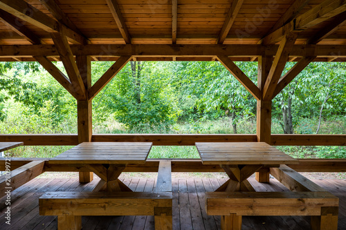 Wooden Shelter With Tables in Park