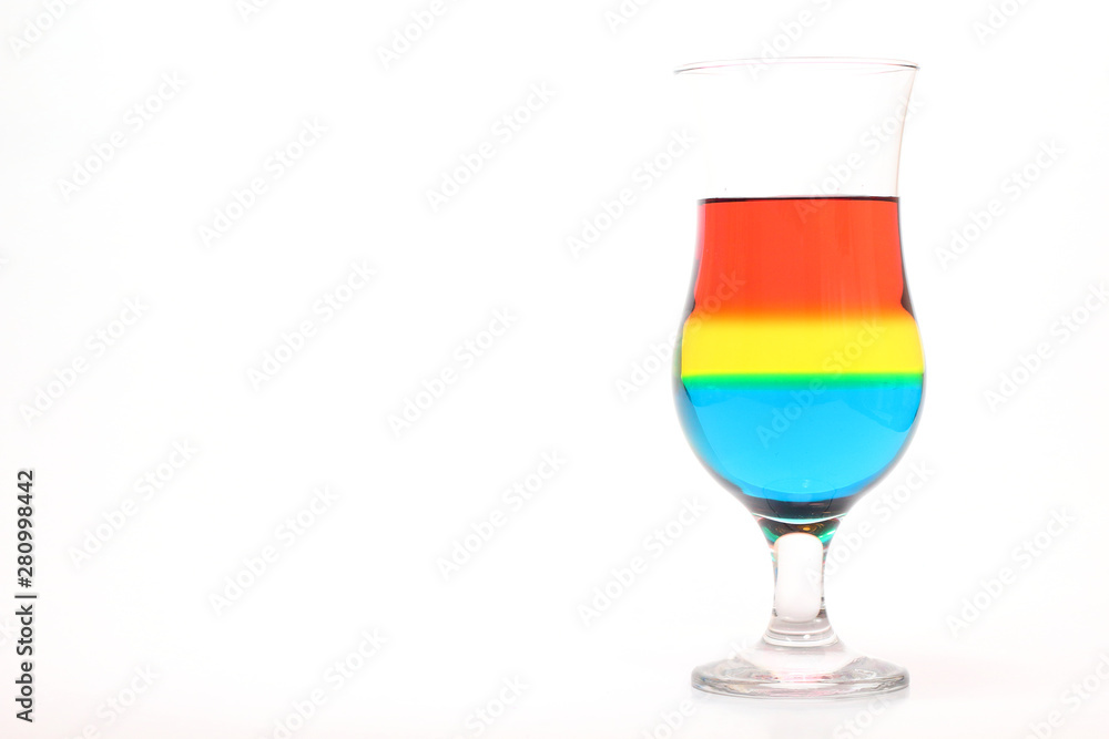 Glass and colored liquids on white background Glass and colored liquids on white background