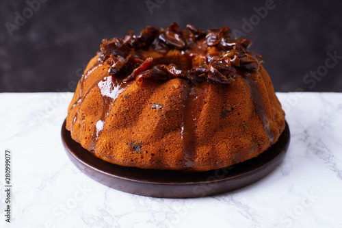 Festive bundt cake with dates and salted caramel. Sticky toffee pudding style photo