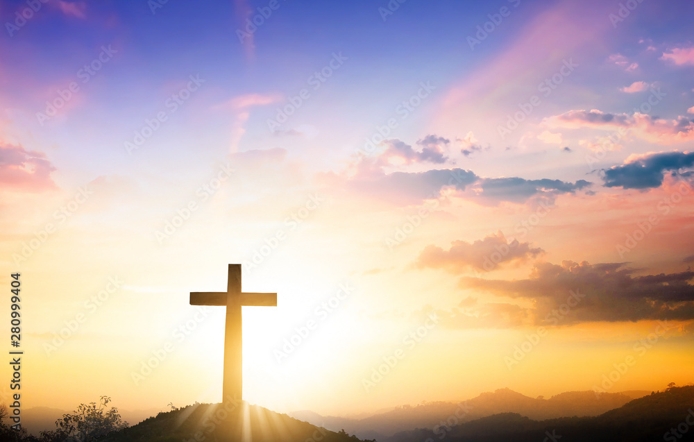 Christmas concept: The cross on mountain sunset background