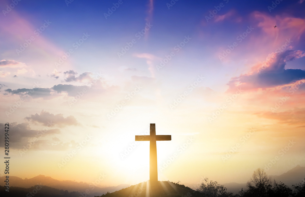Christmas concept: The cross on mountain sunset background