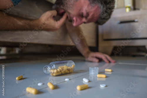 man suffering depression throwing up on bed at home after having pills overdose intoxicated by mix of antidepressant medicines regret on suicide attempt