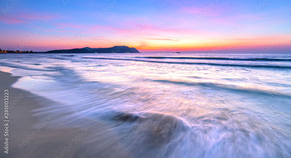 Dawn on the beautiful beach with full of purple colors in the sky welcomes the beautiful new day