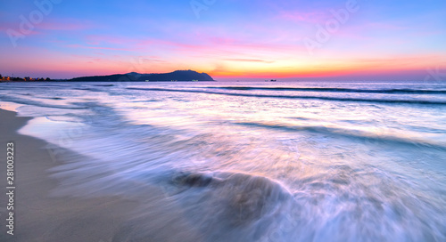 Dawn on the beautiful beach with full of purple colors in the sky welcomes the beautiful new day
