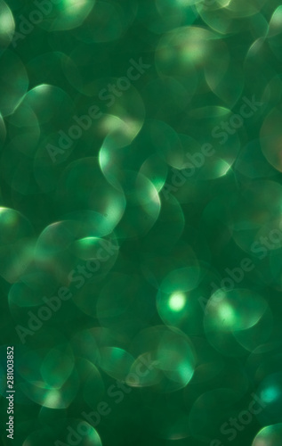 green Lights Festive background with texture. Abstract Christmas twinkled bright bokeh defocused and Falling stars.