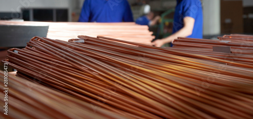 Copper pipes in factory, industrial background. Metal workers in factory.