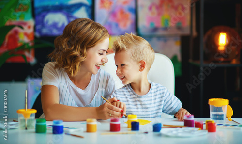 mother and child son painting draws in creativity in kindergarten