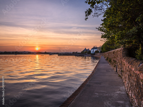 High tide sunset on The Goat Walk with a mirror calm River Exe at Topsham, Devon photo