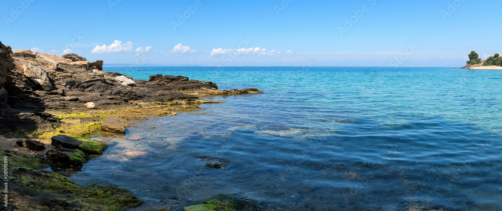 Beautiful seascape with stones and translucent blue water