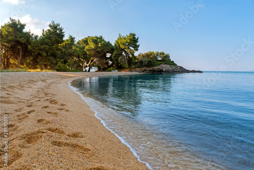 Landscape with deserted beach and clear water. Summer morning on sea