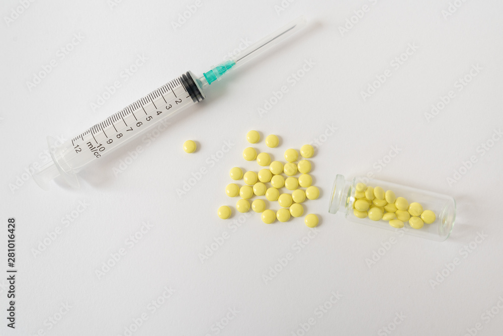Medical syringe and pills on white background, health and vaccination concept. Medical syringe and pills on white background, health and vaccination concept.