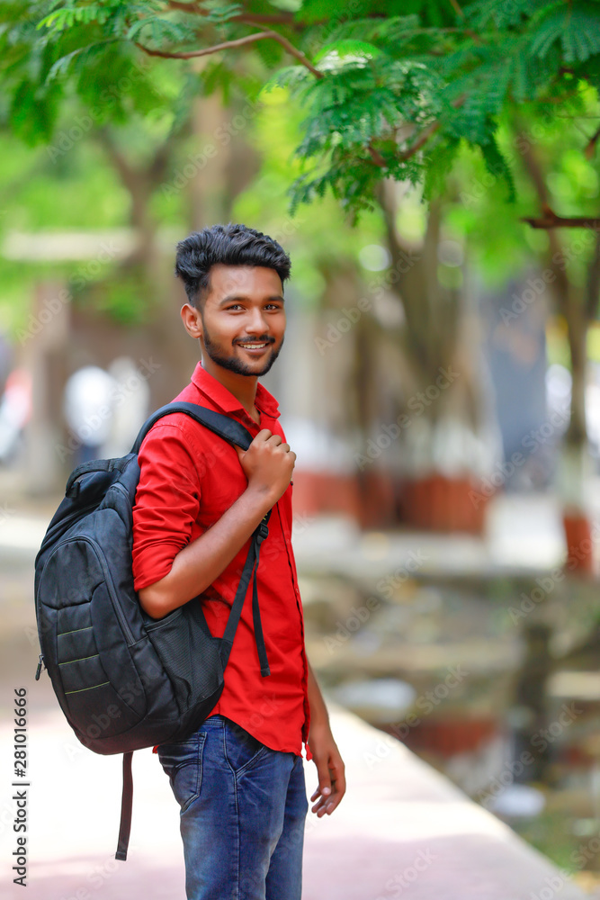 Indian college boy with Holding bag Stock Photo | Adobe Stock