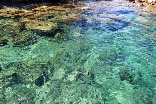 Sea coast and beach with rocks, rocky coastline, blue sea, good sunny day. Summer trip. Beautiful Greece. Most beautiful beach, natural environment, waves and tropical landscape, horizon and panorama.