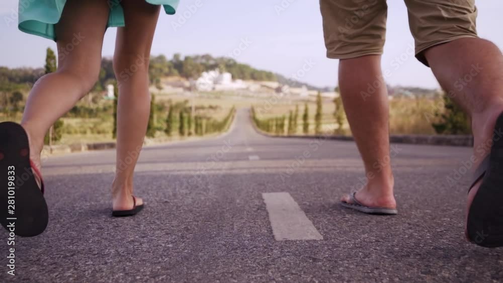 Young man and woman, go on a straight road around the trees. Young man and woman, go on a straight road around the trees.