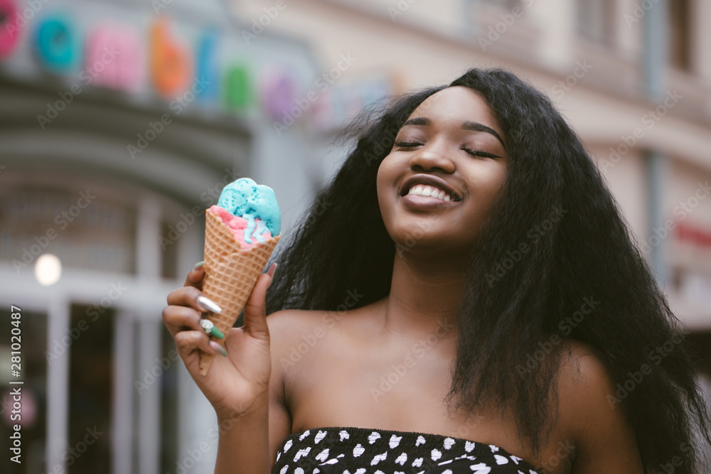 Portrait of happy young woman laughing with ice cream in the city Portrait of happy young woman laughing with ice cream in the city