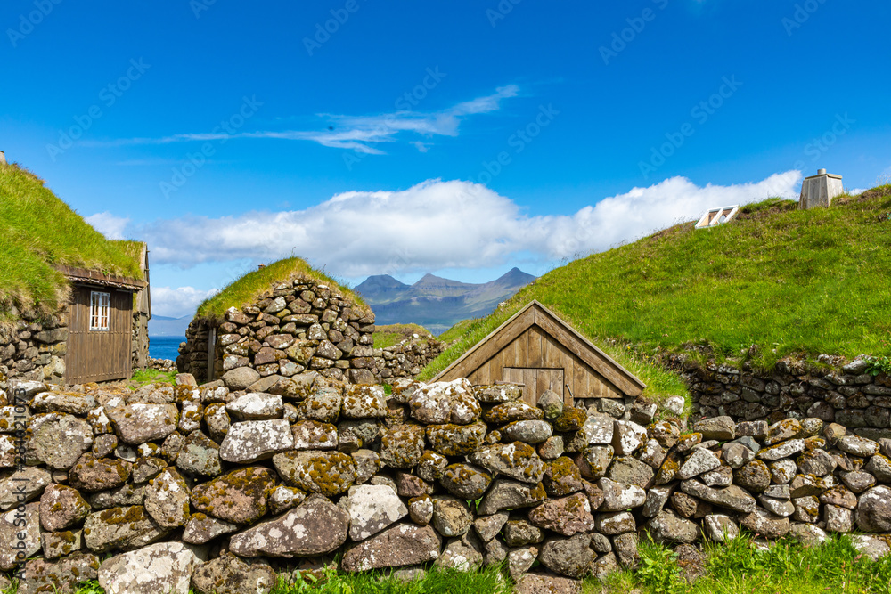 View of fishing village in Koltur island. Faroe Islands. Green roof houses. Nordic natural landscape.