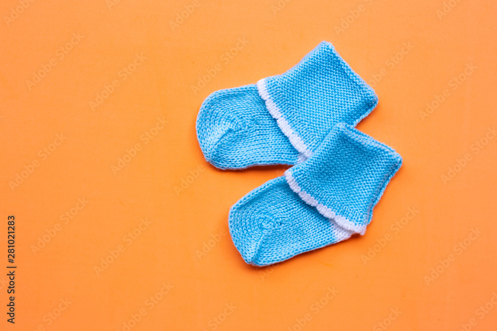 Baby socks on orange background. Baby socks on orange background.