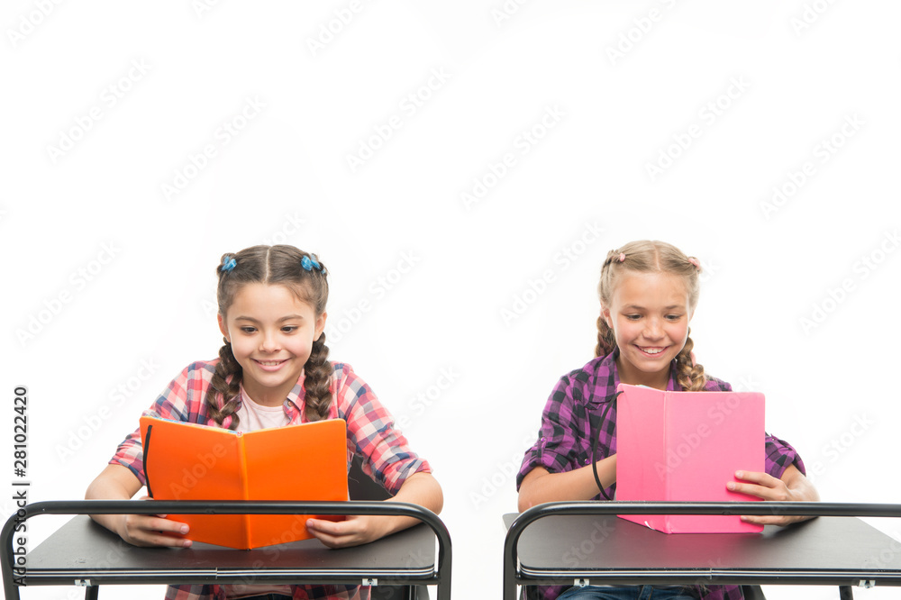Reading opens doors. Small children reading books isolated on white. Adorable little girls learn reading at primary school. Cute pupils acquiring the basic knowledge and skills such as reading Reading opens doors. Small children reading books isolated on white. Adorable little girls learn reading at primary school. Cute pupils acquiring the basic knowledge and skills such as reading