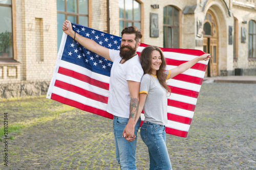 National holiday. Bearded hipster and girl celebrating. 4th of July. American patriotic people. American citizens couple USA flag outdoors. Patriotic spirit. Independence day. American tradition