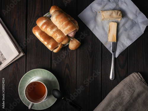 cup of coffee and croissant on wooden table