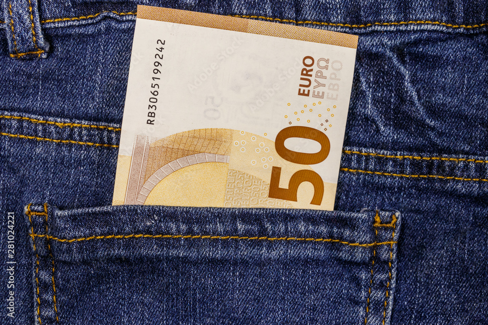 Fifty euro banknote in the pocket of blue jeans Fifty euro banknote in the pocket of blue jeans