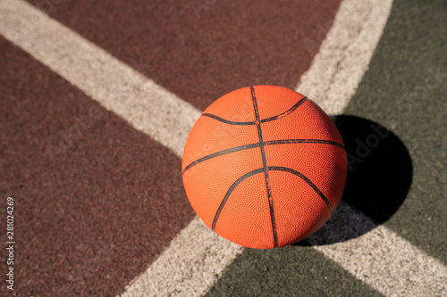 Overview of basketball gear on crossing of two white lines on stadium
