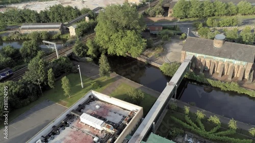 Train passing over British urban canal in suburban town district.