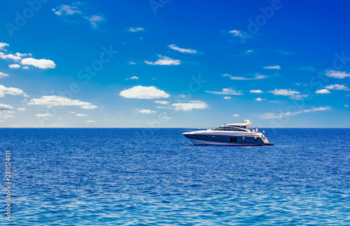 idyllic picturesque expensive cruise vacation concept photography of Mediterranean sea scenery landscape and lonely yacht floating on water, blue sky with white clouds background, empty space for text
