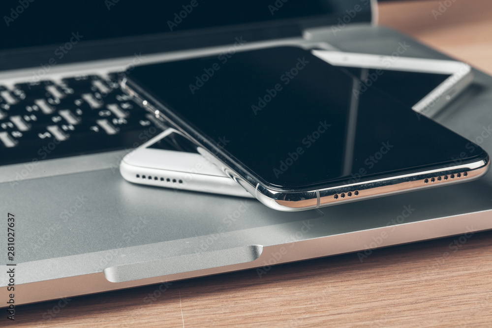 Laptop and mobile phone on the table. Workspace concept. Laptop and mobile phone on the table. Workspace concept.