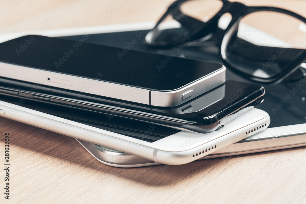 Digital tablet and mobile phone. Electronic devices on wooden table, close up. Digital tablet and mobile phone. Electronic devices on wooden table, close up.