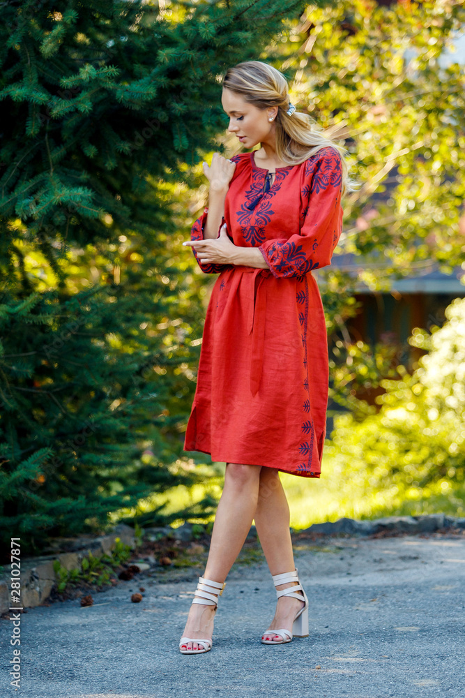 Beautiful blonde Ukrainian girl with blue eyes in folk clothing. Boho style in fashion. Traditional and nature style. National look Beautiful blonde Ukrainian girl with blue eyes in folk clothing. Boho style in fashion. Traditional and nature style. National look