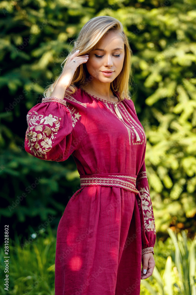 Beautiful blonde Ukrainian girl with blue eyes in folk clothing