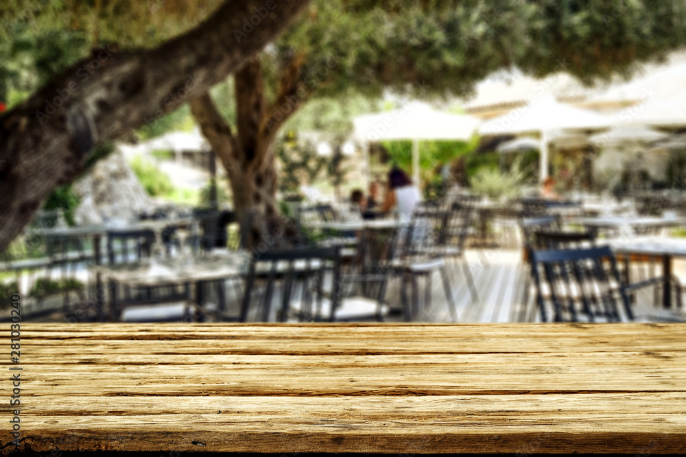 Table background with blurred restaurant in distance.