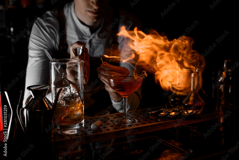 Close-up of bartender firing up a cocktail