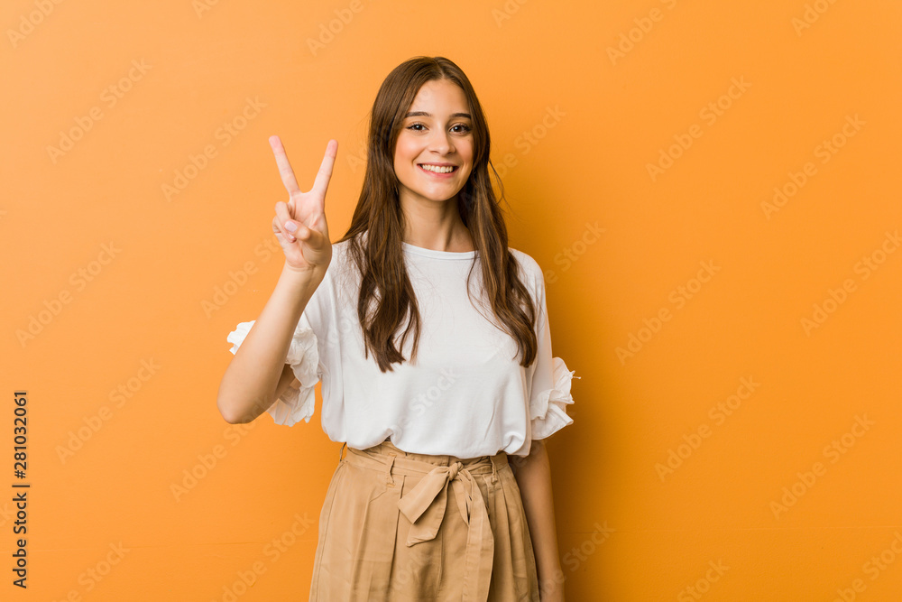 Young caucasian woman showing number two with fingers. Young caucasian woman showing number two with fingers.