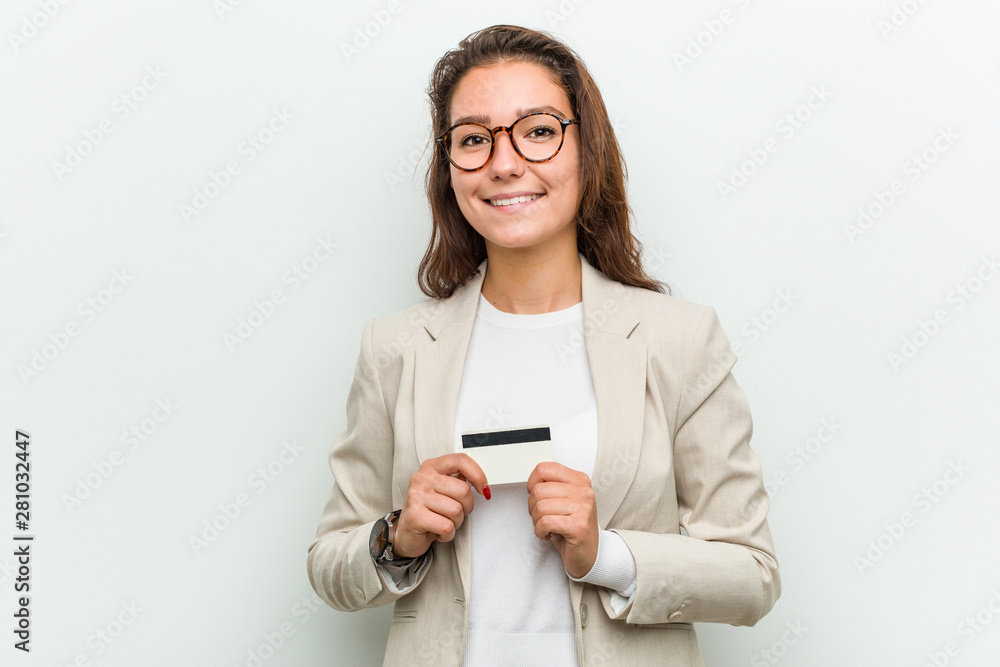 Young european business woman holding a credit card happy, smiling and cheerful. Young european business woman holding a credit card happy, smiling and cheerful.